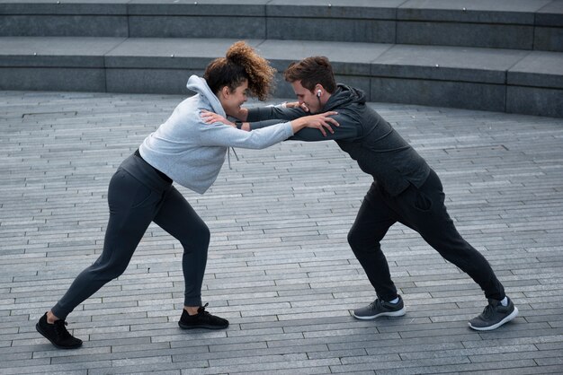 Full shot man and woman competing