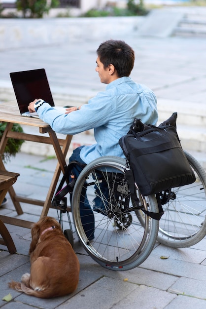 Full shot man working on laptop