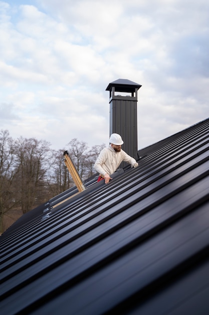 Full shot man working on roof