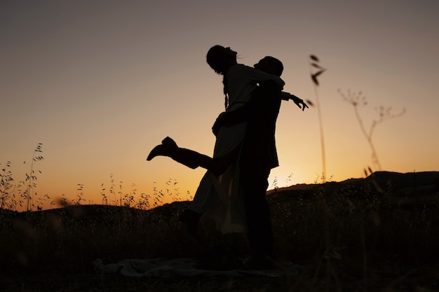 Full shot married couple silhouettes