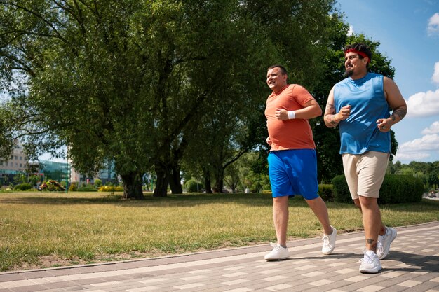 Full shot men exercising together outdoors