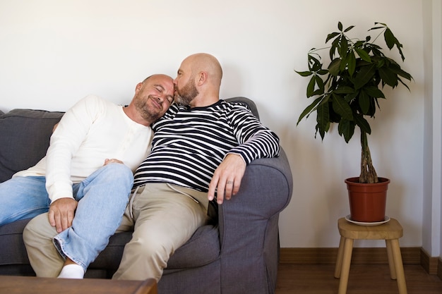 Full shot men laying on couch