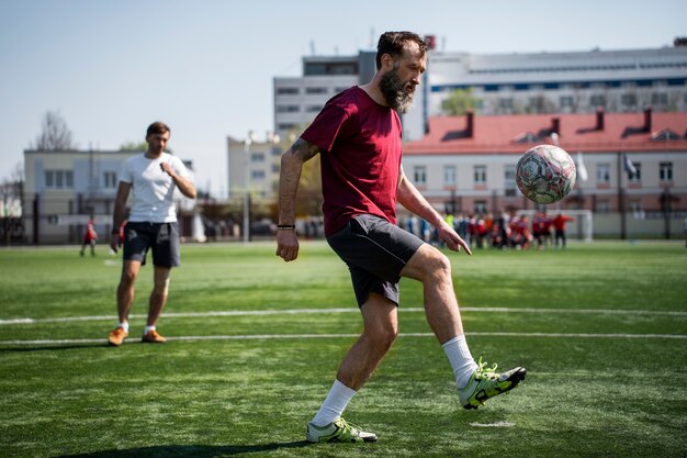 Full shot men playing soccer