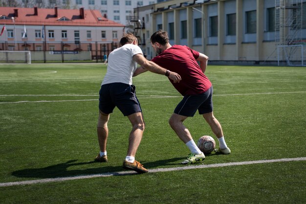 Full shot men playing soccer