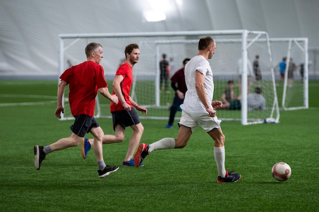 Full shot men playing soccer