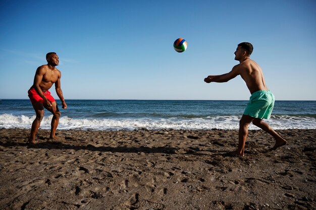 Full shot men playing volleyball