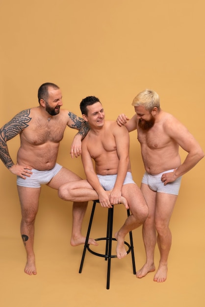 Free photo full shot men posing together in studio