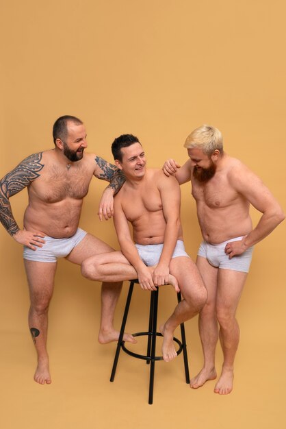 Full shot men posing together in studio