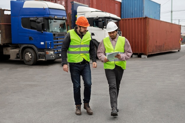 Full shot men wearing helmets and vests