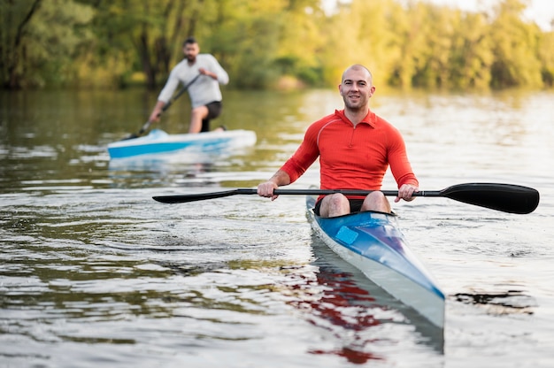 Full shot men with oars