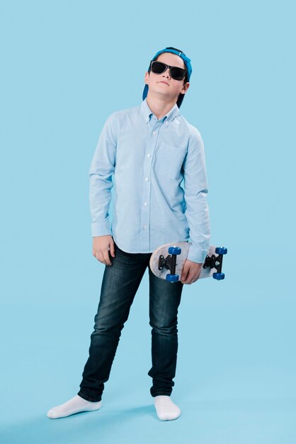Full shot of modern boy with skateboard
