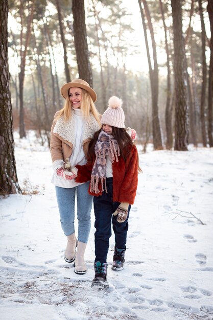 Full shot mother and girl outdoors