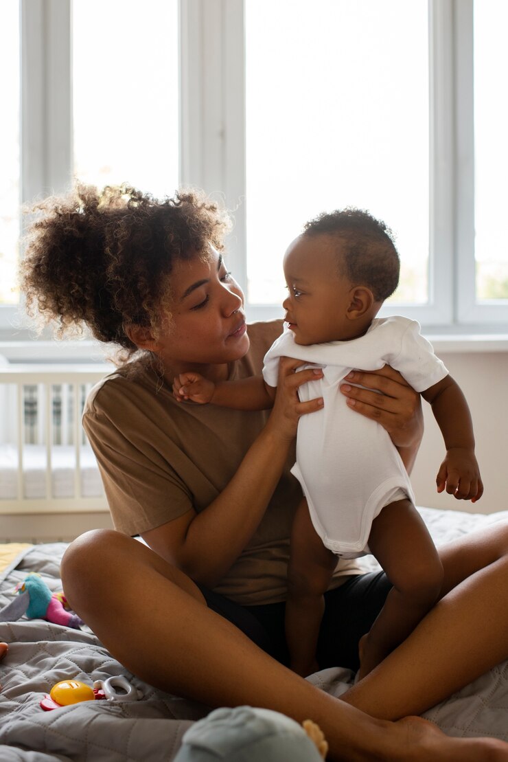 Free Photo full shot mother holding cute baby