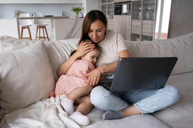 Full shot mother hugging girl