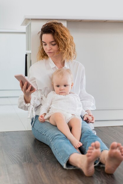 Full shot mother with phone