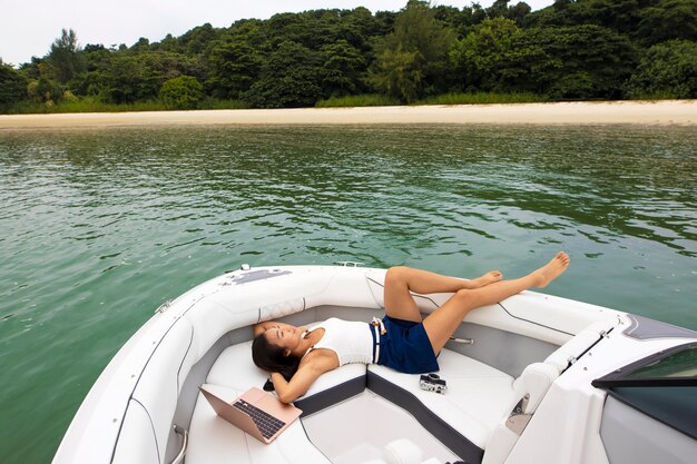 Full shot nomad woman relaxing on boat