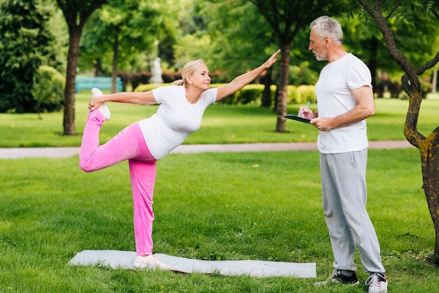 Full shot old couple exercising outdoors
