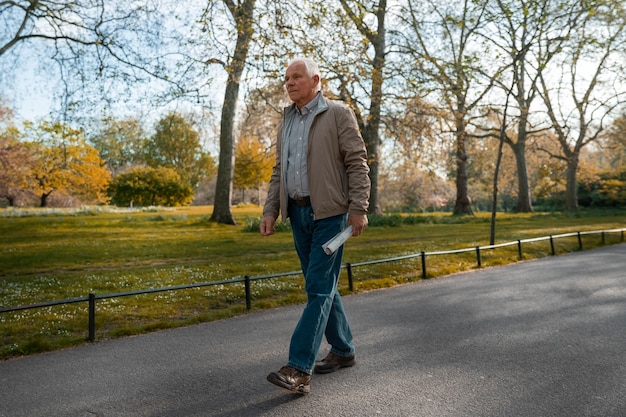 Free photo full shot old man taking a stroll