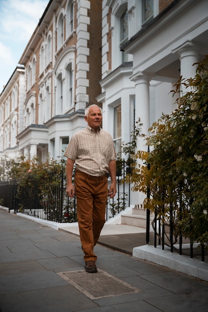 Free photo full shot old man taking a stroll