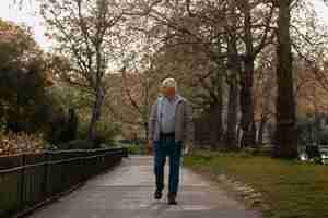 Free photo full shot old man taking a stroll