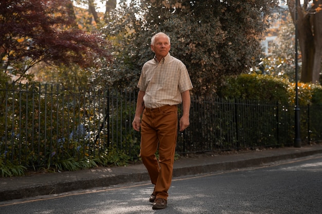 Free photo full shot old man taking a stroll