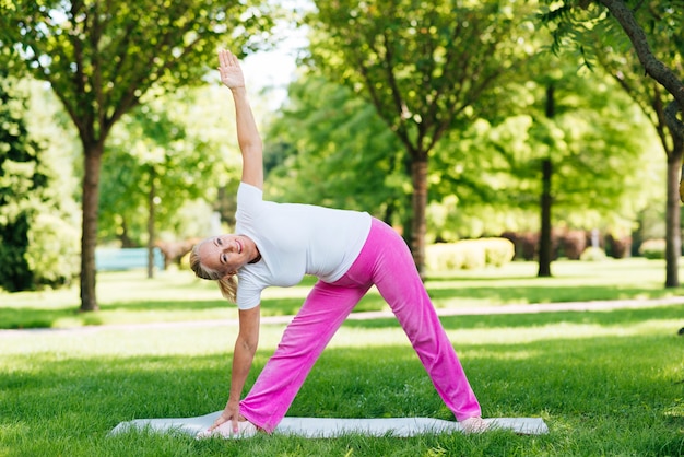 Full shot old woman exercising outdoors