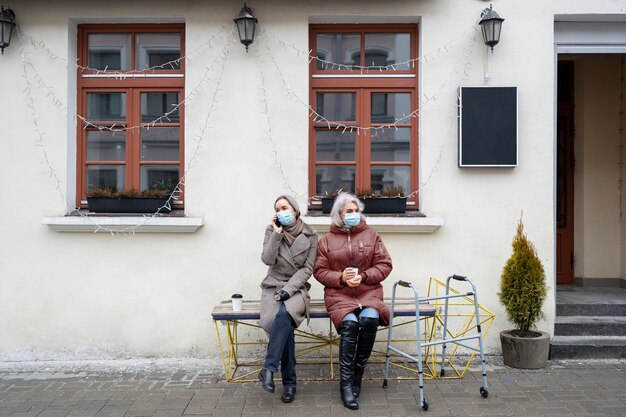 Full shot old women sitting on bench