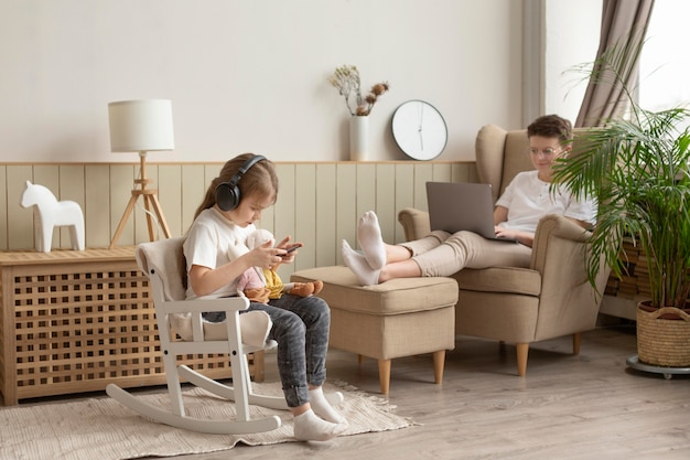 Full shot parent and child with devices