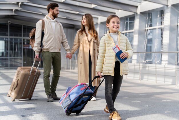 Full shot parents and kid traveling