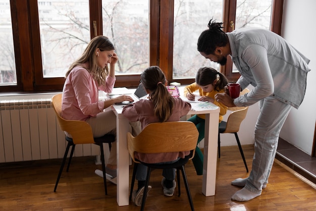 Full shot parents and kids at home