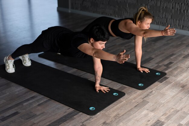 Full shot people in barre group class