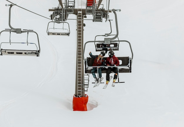 Full shot people on chairlift