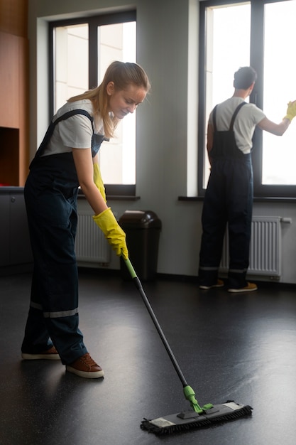 Free photo full shot people cleaning office