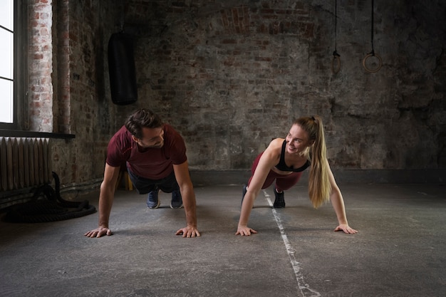 Free photo full shot people doing burpees together