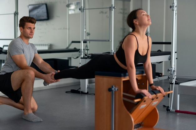 Full shot people doing pilates