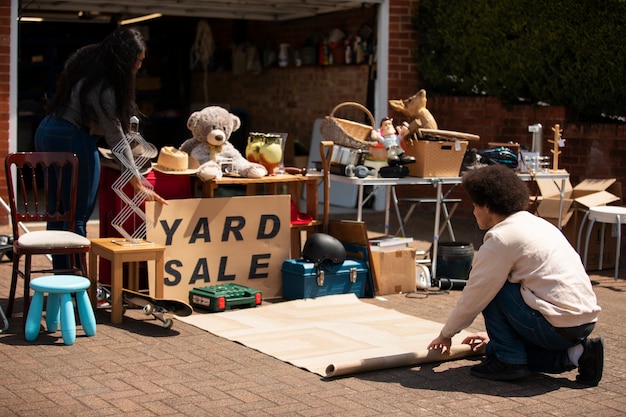 Full shot people at garage sale