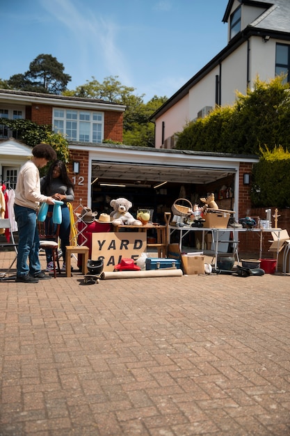 Full shot people at garage sale