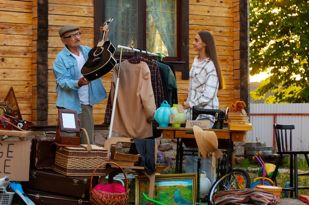 Full shot people at garage sale