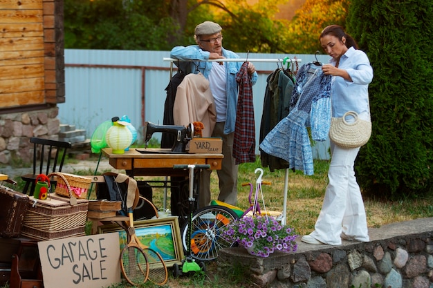 Full shot people at garage sale