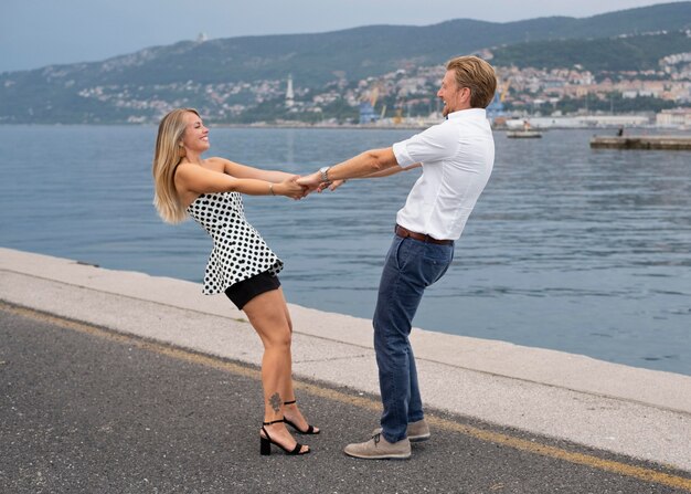 Full shot people holding hands outdoors