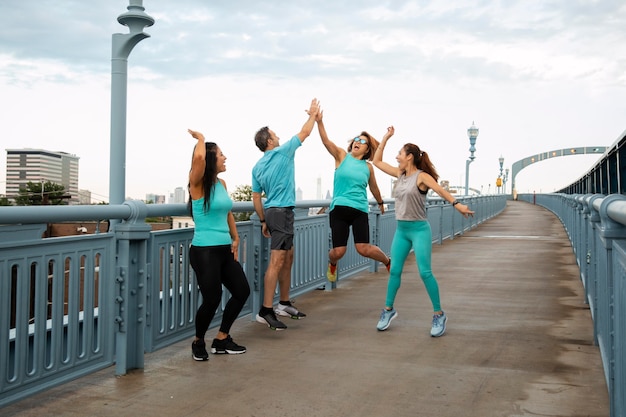 Full shot people jumping outdoors