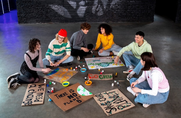 Full shot people making banners together