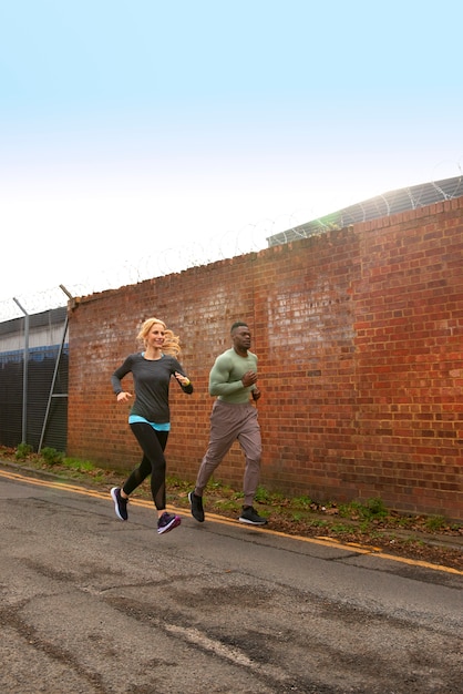 Full shot people running outdoors