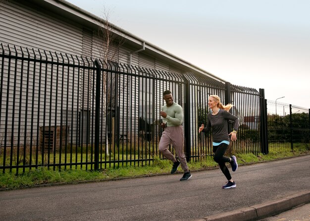 Full shot people running outdoors