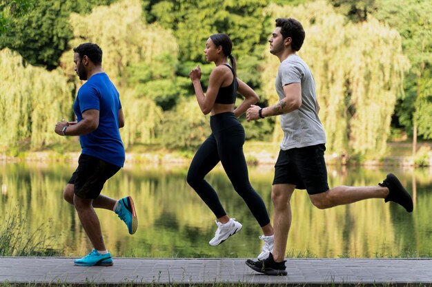 Full shot people running together outdoors