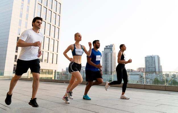 Full shot people running together outdoors