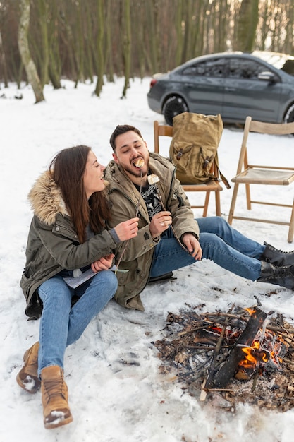 Free photo full shot people sitting outdoors