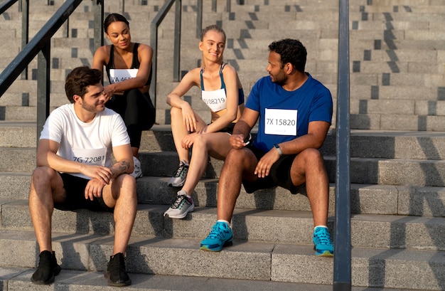 Full shot people sitting on stairs