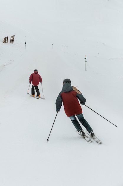 Full shot people skiing