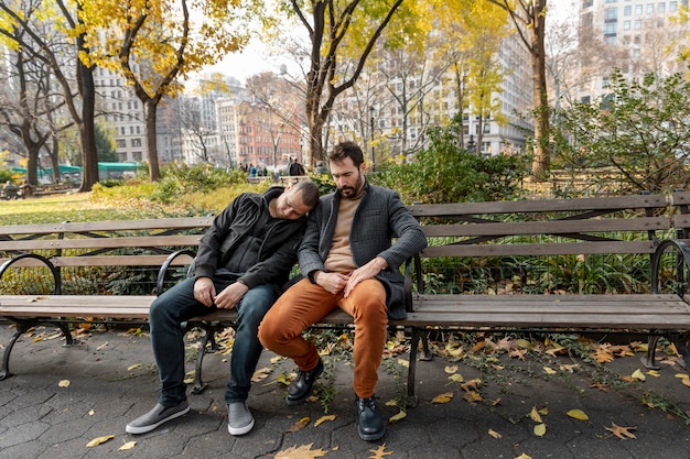 Full shot people sleeping on bench